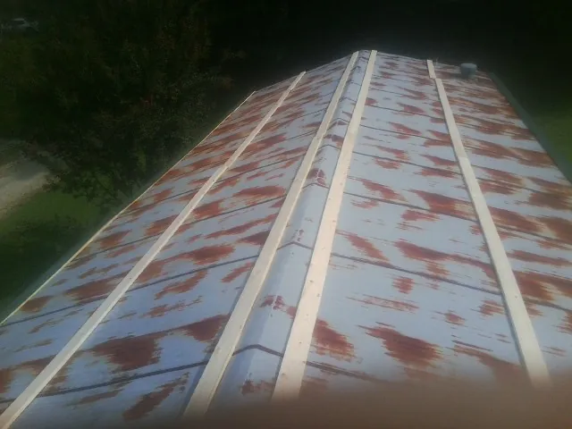 Rusted metal roof panels with new wood purlins before replacement — Storm Damage Roof Repair in Forest Knolls by Roofing Brothers