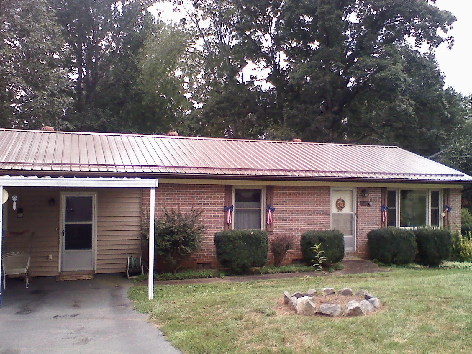 Bronze metal roof and carport on a brick ranch home — Roof Repair work by our crew in Forest Knolls