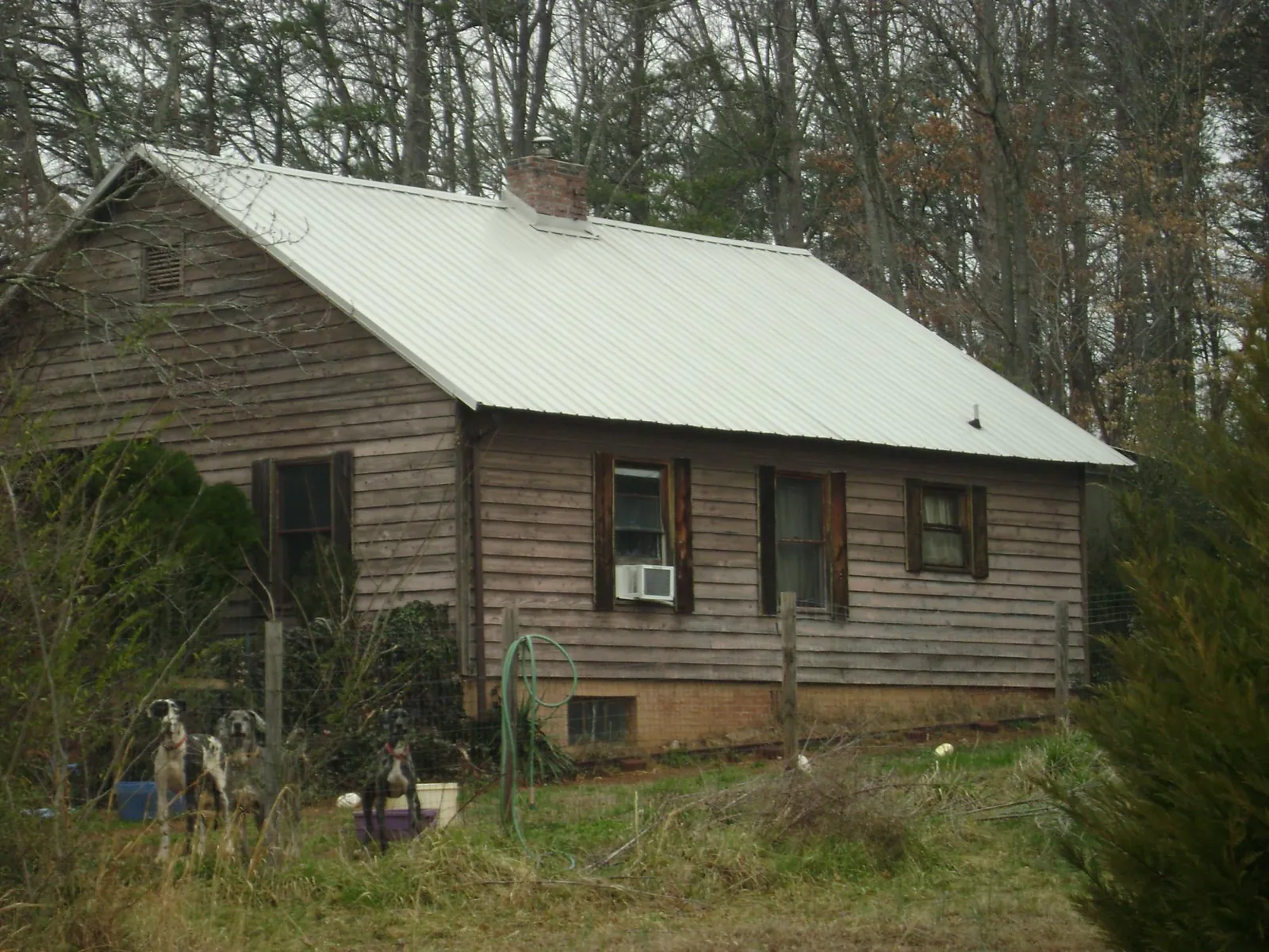White metal roof on an old wood sided farmhouse, from a Metal Roof Installation job in Forest Knolls